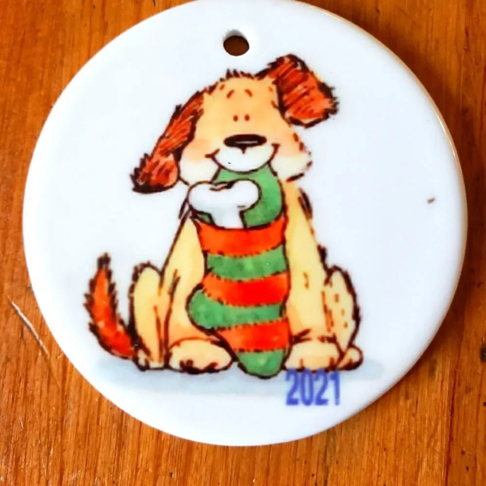 Dog with stocking, 3 inch white ceramic ornament